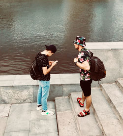Rear view of people standing in water