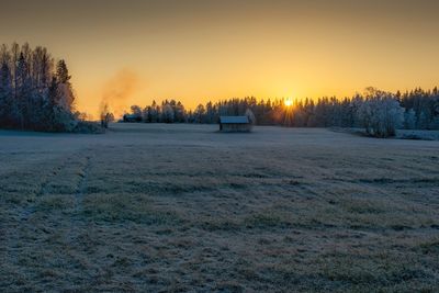 Scenic view of snow field against sky during sunset