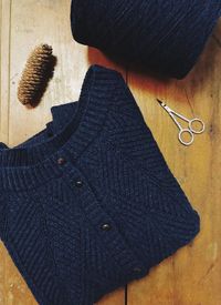 Close-up of sweater and scissors on table