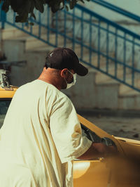 Rear view of a blind man standing 