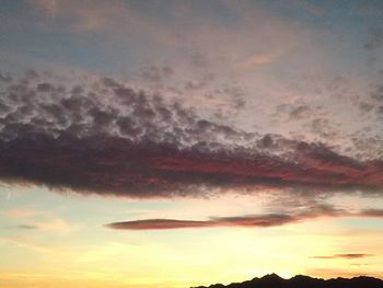 Low angle view of cloudy sky at sunset