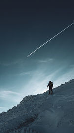 Rear view of man walking on mountain