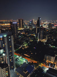 High angle view of illuminated buildings against sky at night