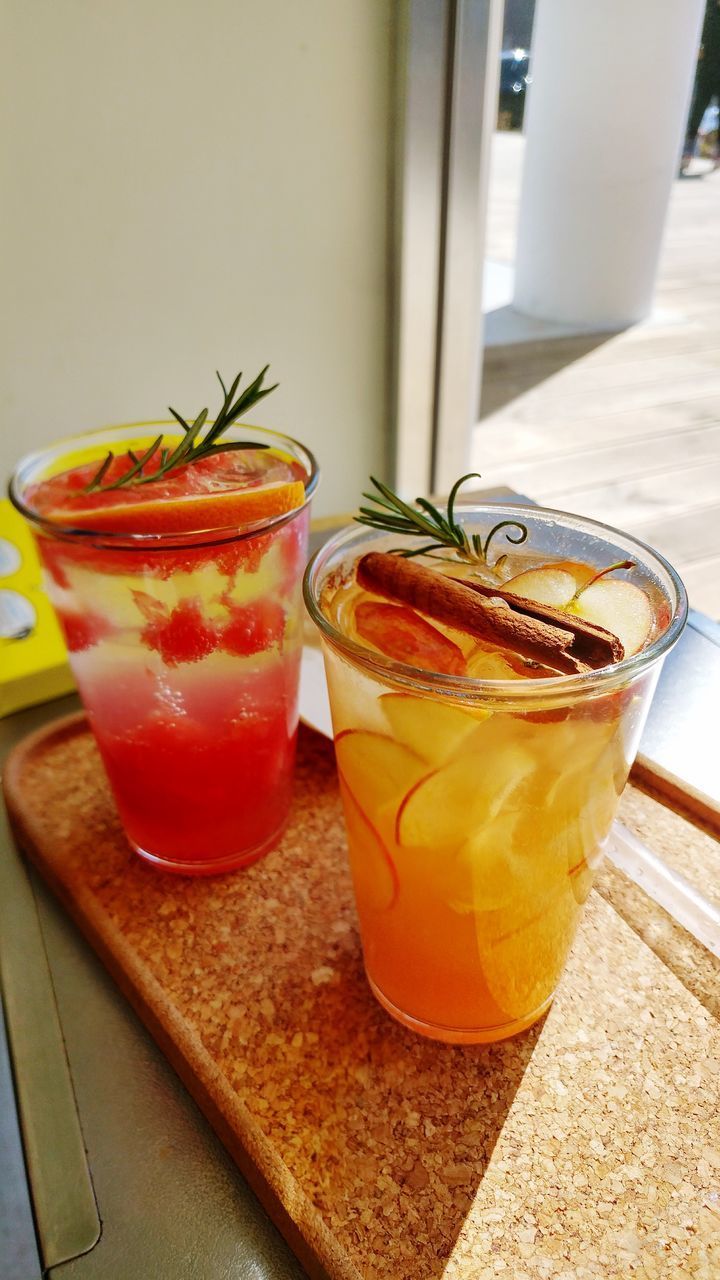 CLOSE-UP OF JUICE WITH DRINK ON TABLE AT HOME