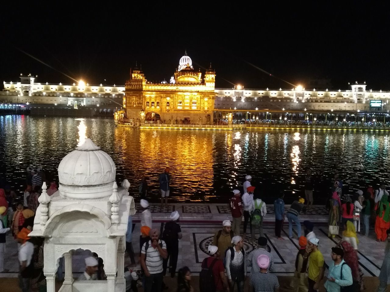 VIEW OF ILLUMINATED BUILDINGS AT WATERFRONT