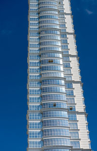 Low angle view of modern building against clear blue sky