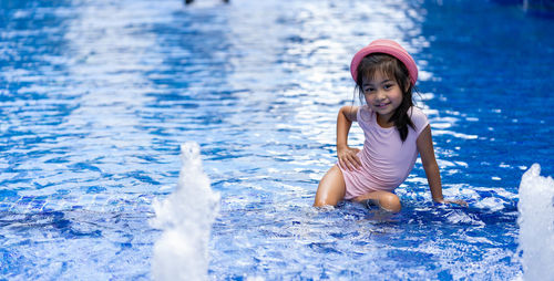 Portrait of cute girl in swimming pool