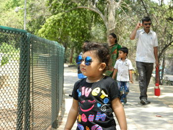 Portrait of woman standing on tree trunk