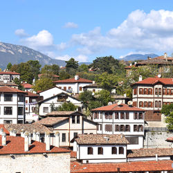 Houses in town against sky