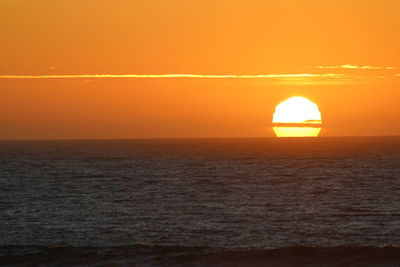 Scenic view of sea against orange sky