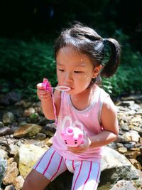 High angle view of girl playing with bubble wand