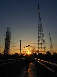 Silhouette bridge against sky during sunset