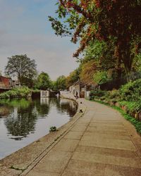 River amidst trees and buildings against sky