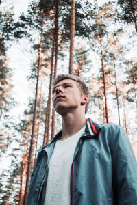 Portrait of young man in forest