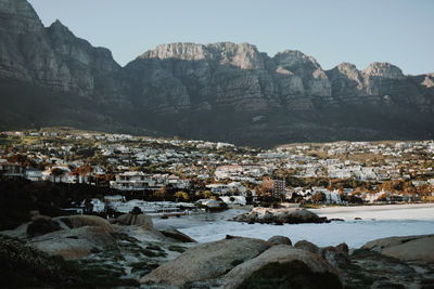 Scenic view of sea and mountains against clear sky