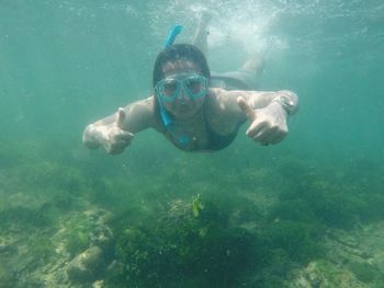 Portrait of woman swimming undersea