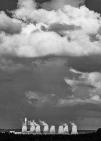 Low angle view of buildings against cloudy sky