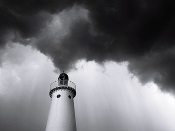 Low angle view of lighthouse against cloudy sky