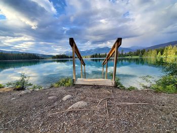 Scenic view of swimming pool by lake against sky