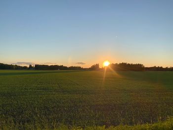 Scenic view of field against sky during sunset