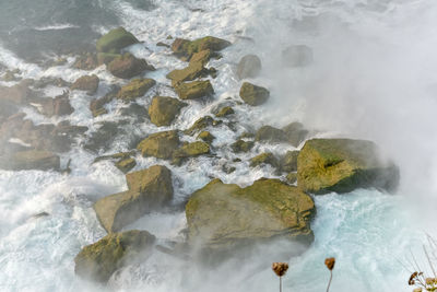 High angle view of rocks in sea