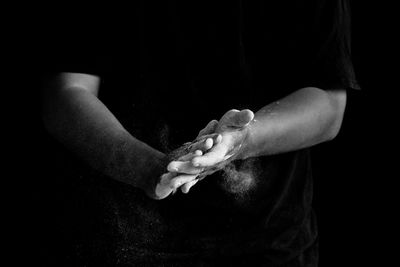 Close-up of hands over black background