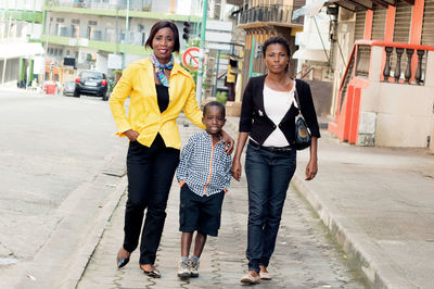 This family , together made a little walk in the street.