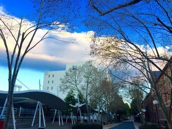 Buildings in city against blue sky