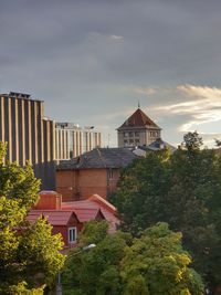 High angle view of buildings against cloudy sky