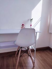 Table and chairs on hardwood floor against wall at home