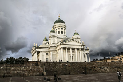 Low angle view of historical building against cloudy sky