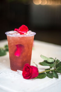Close-up of rose in glass on table