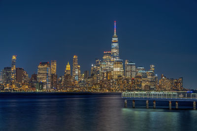 Illuminated city at waterfront