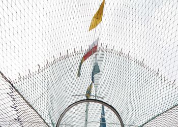 Low angle view of yellow flag against sky