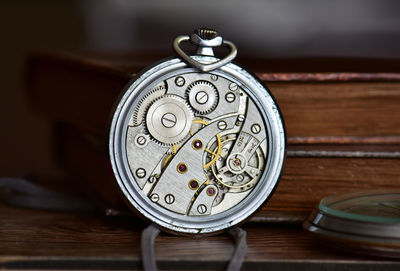 Close-up of pocket watch machinery on table