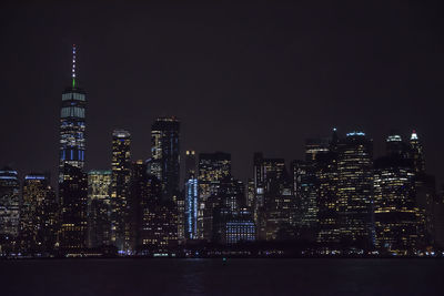 Illuminated buildings against sky at night