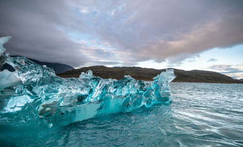 View of ice floating on sea against sky