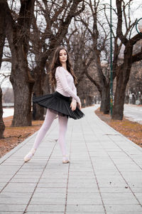 Ballerina dancing on footpath