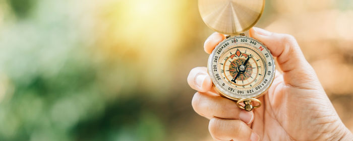 Cropped hand holding pocket watch