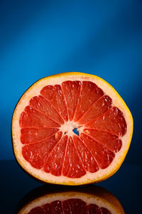 Close-up of orange slices against blue background