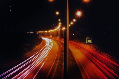 High angle view of light trails on road at night