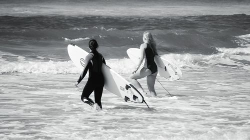 Rear view of people at beach