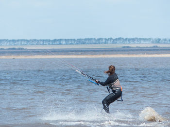 Full length of woman on beach against sky