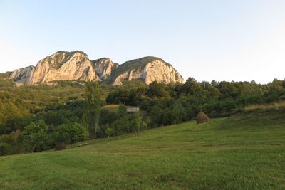 Scenic view of landscape and mountains against clear sky