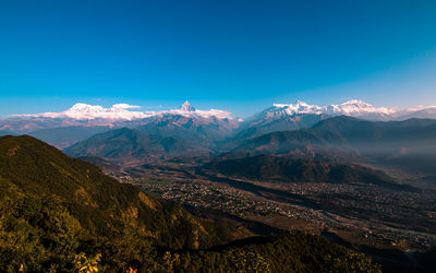 Scenic view of mountains against clear blue sky