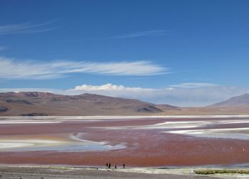 Scenic view of a pink lake against sky and mountains