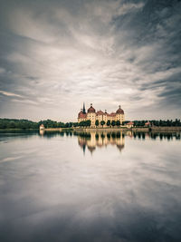 Reflection of building in lake at sunset