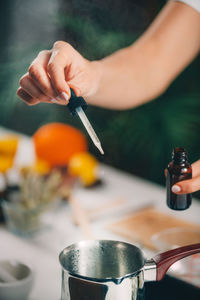 Midsection of person preparing food in kitchen