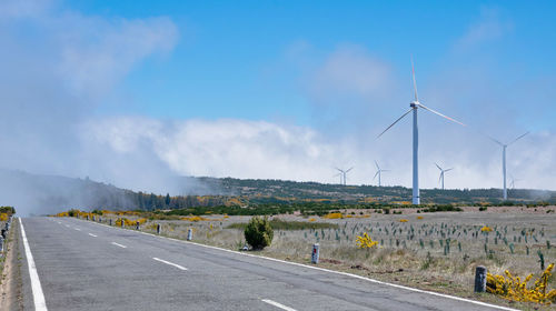 Road by landscape against sky