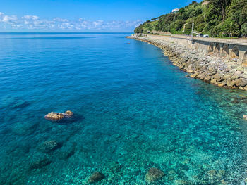 High angle view of rocks by sea against sky